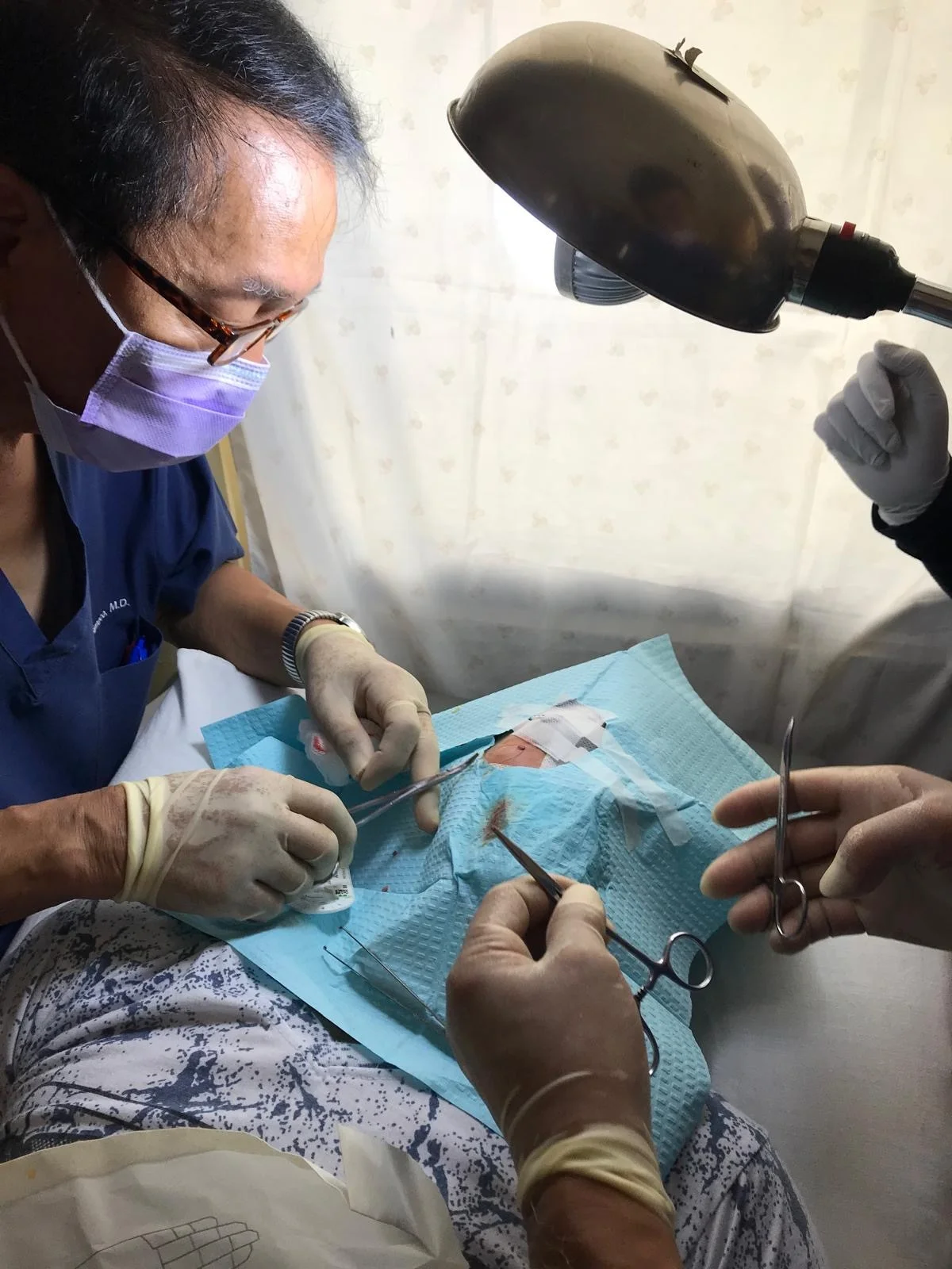 Medical team performing a clinical procedure on a patient