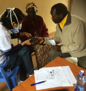 Medical volunteer providing medical care to a patient
