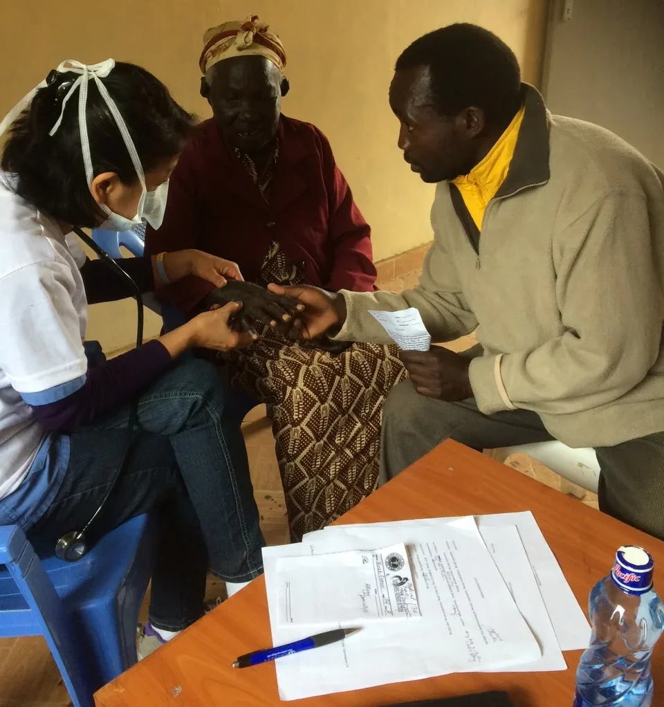 Medical volunteer providing medical care to a patient